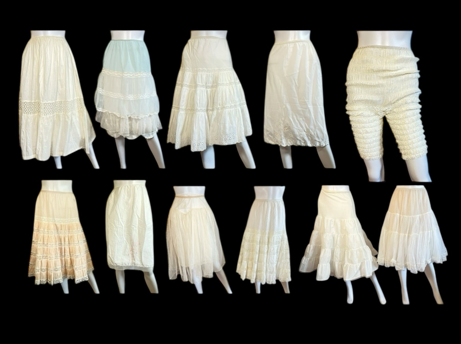 A Collection of Antique and Vintage Half Slips & Petticoats: Includes an assortment of styles and sizes, mostly white. Sizes range from S-L. Includes 19 half slips or petticoats and one pair of bloomers.