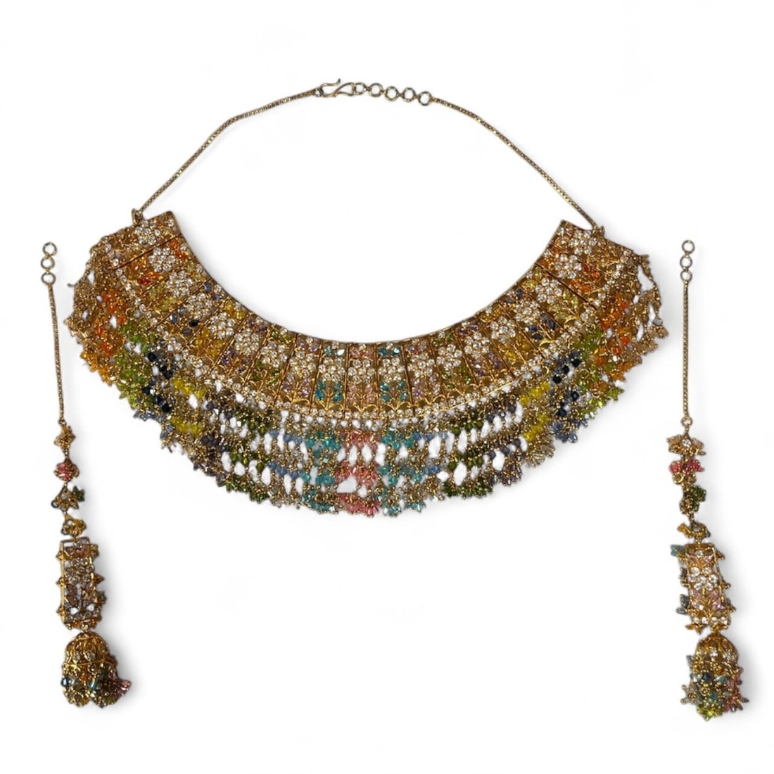 An Exceptional Traditional Indian Jewelry Set: Gold toned metal with multicolor stones. Necklace measures 9" x 3" at the front, total length of 16.5". Earrings measure 2.5" long, chain on earrings measures 5" long.