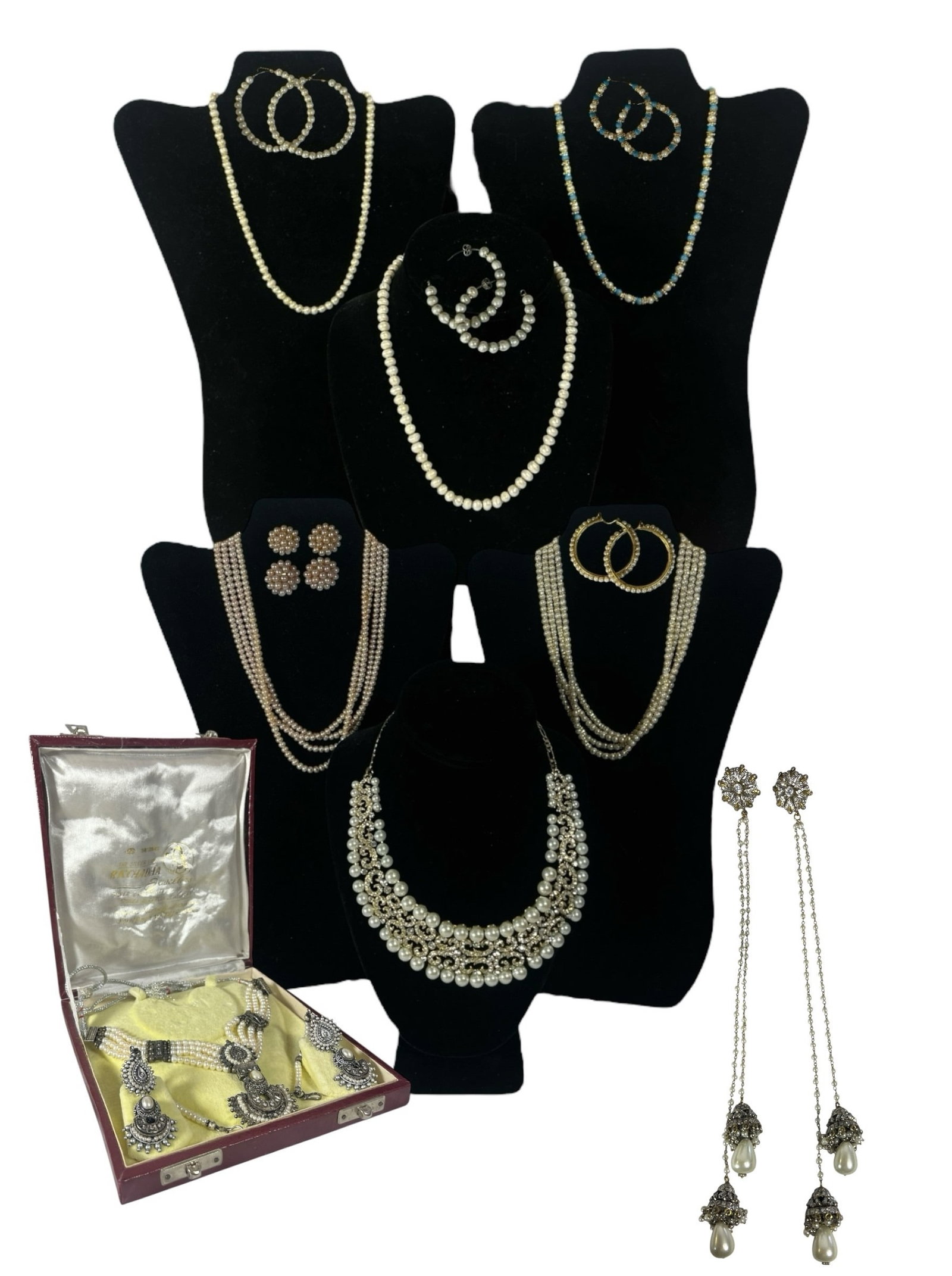 A Large Collection of Indian Pearl Jewelry: Includes 8 matching sets of necklace and earrings as well as an additional necklace. Likely all cultured pearls. Largest earrings measure 2.5" DIA, longest necklace measures 18" total length.