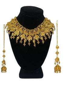 A Traditional Indian Gold Tone Jewelry Set