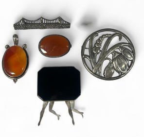 An Assortment of Sterling Silver, Onyx, Carnelian, & Marcasite Brooches