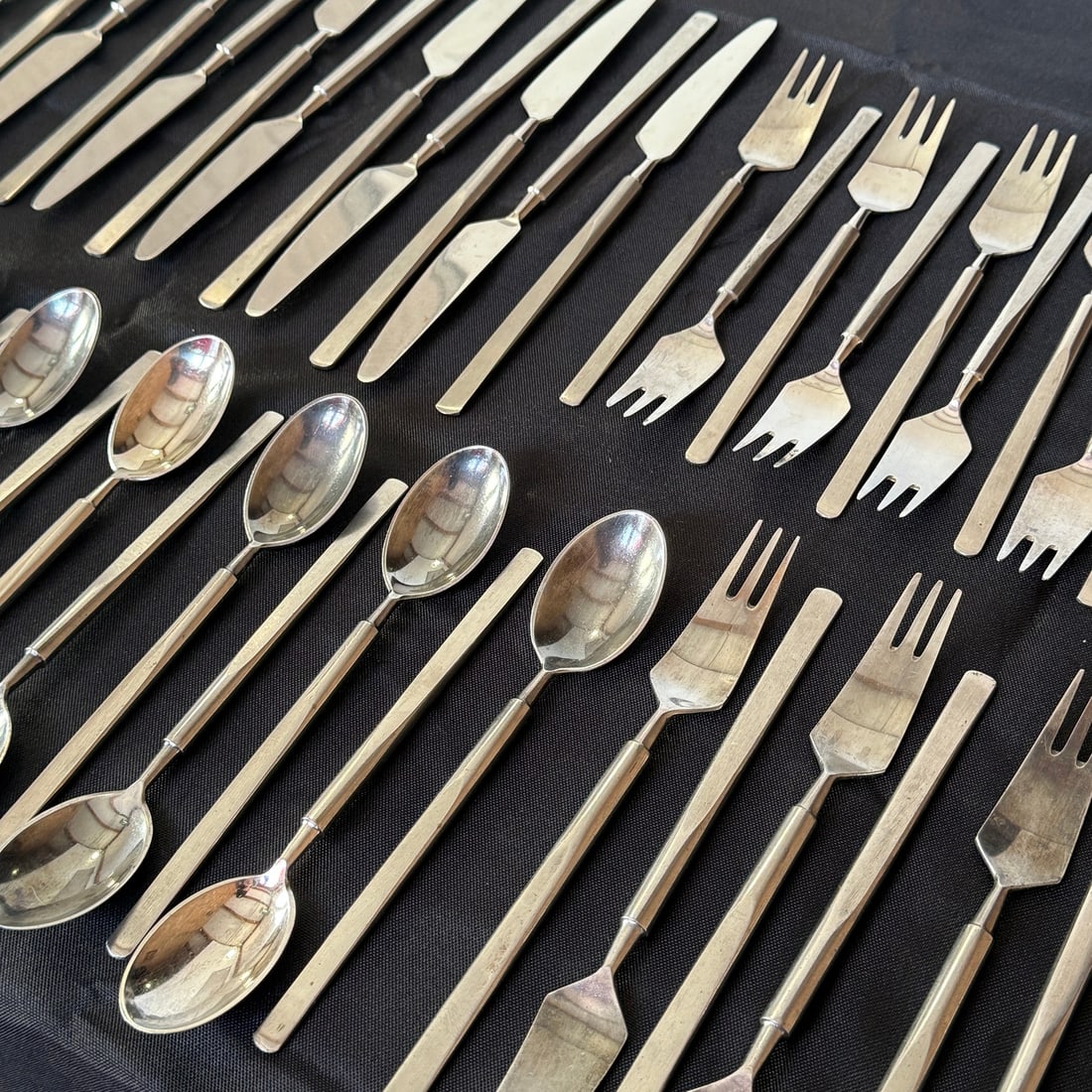 ERIK HERLOW "Obelisk" Flatware Set (63): Stainless steel. Manufactured by Copenhagen Cutlery, Denmark. Manufacturer's mark on each. 1 serving fork, 5 assorted serving spoons, 14 salad forks, 7 dinner forks, 11 teaspoons, 12 spoons, 13 knives