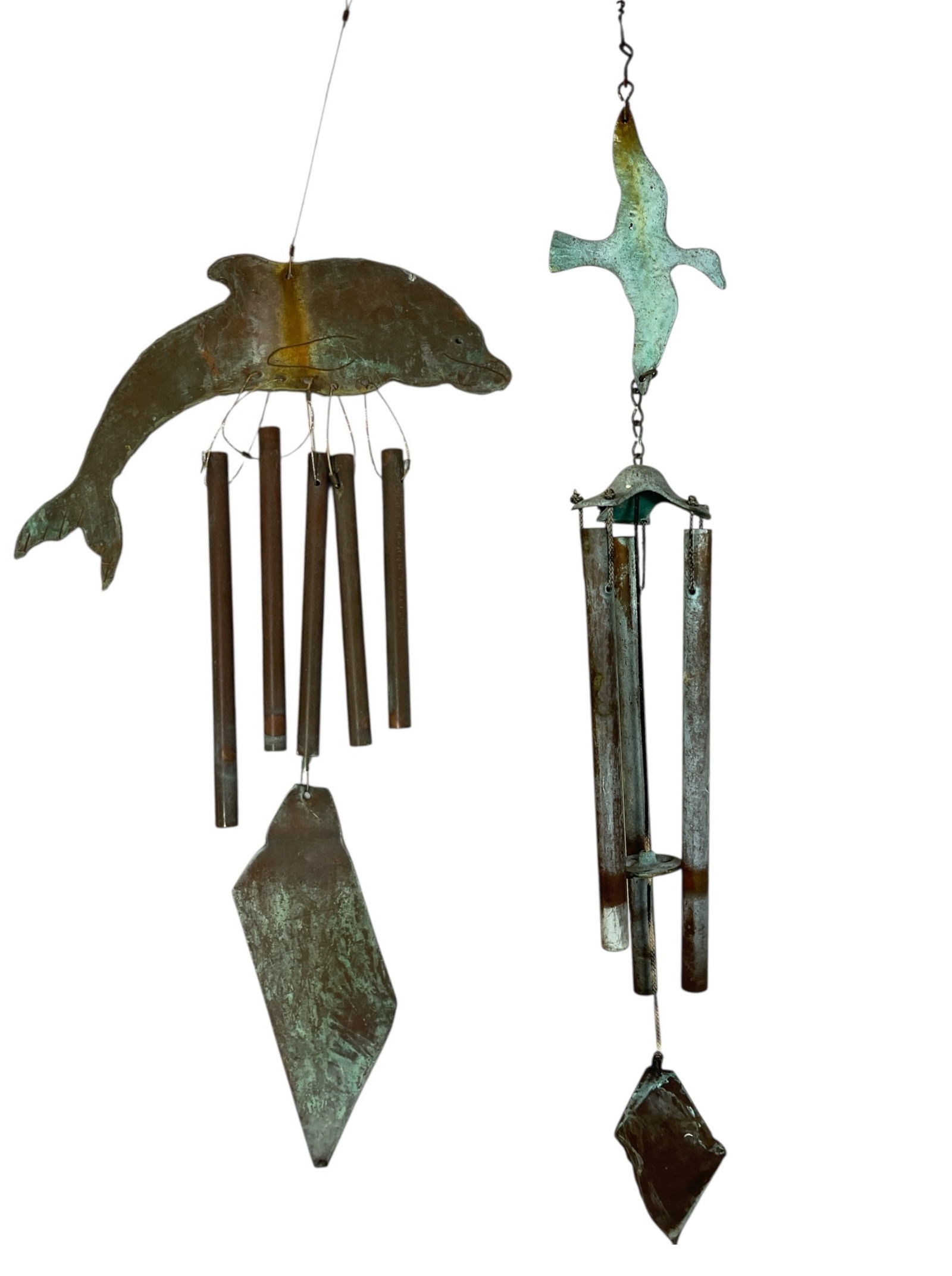 Two Patinated Bronze & Copper Windbells: In the style of Paolo Soleri. The dolphin windbell measures 25.5" long x 10.5" at the widest and the duck windbell measures 28" long x 3.5" at the widest.