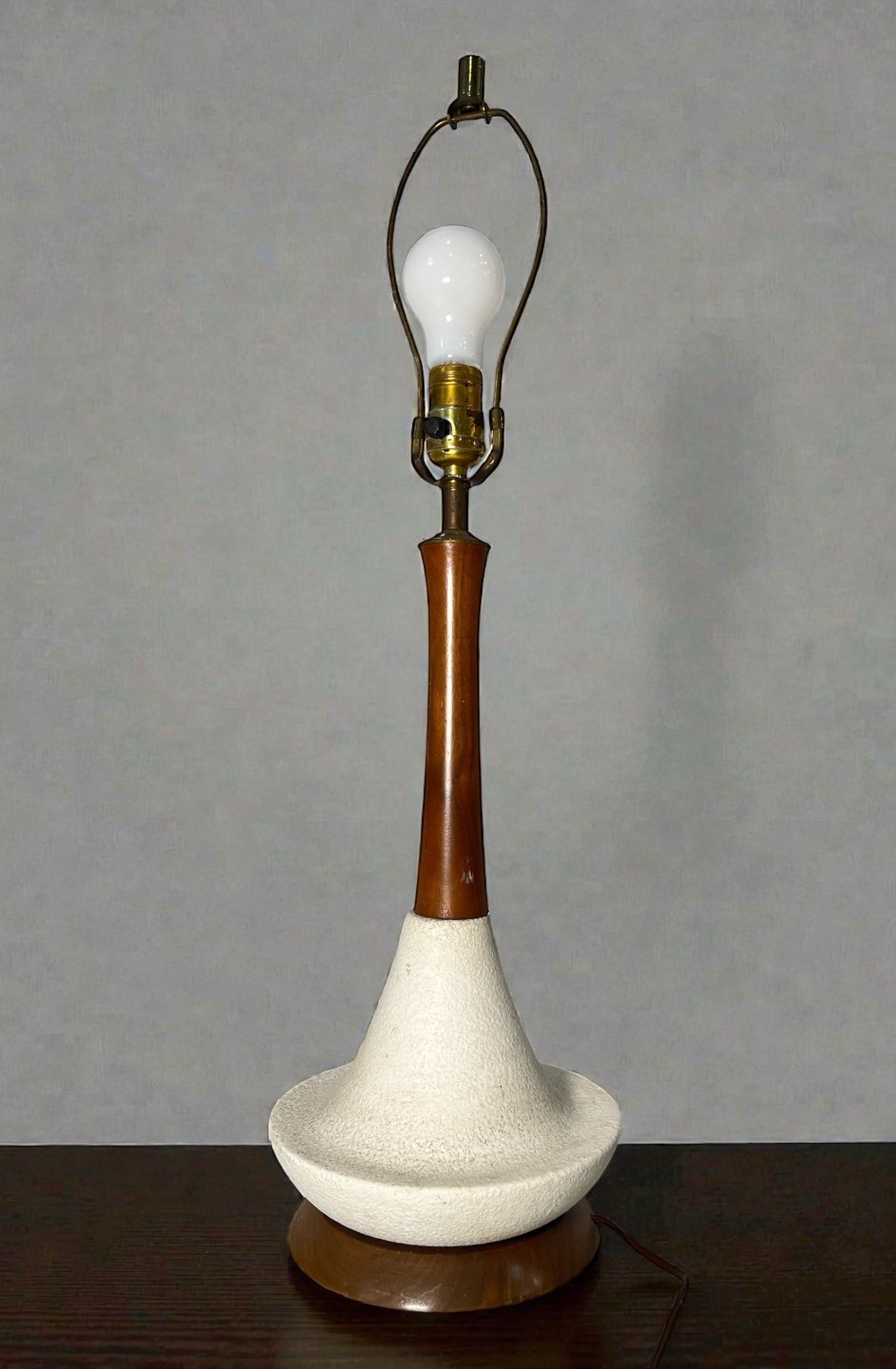 A Danish Mid Century Teak Table Lamp: Measures 27.25" H x 8" DIA at base. Teak and ceramic base.