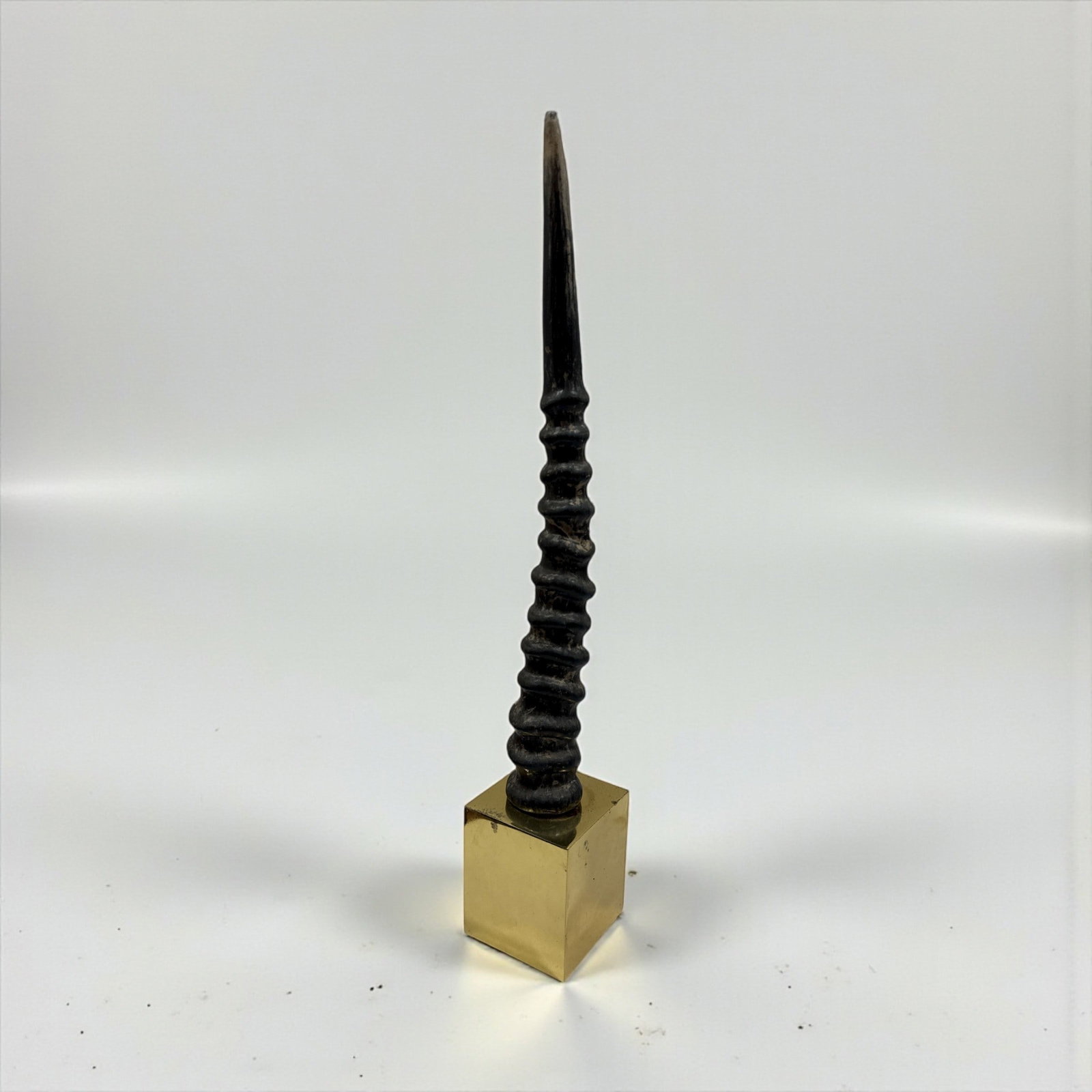 Faux Gemsbok Horn Sculpture on Base: Measures 21.75" H x 3.25" W x 3.25 D at base.