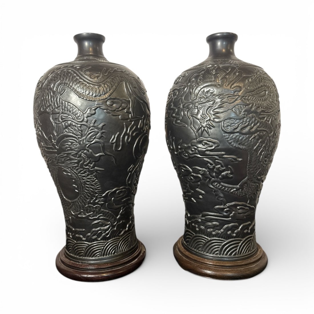 A Pair of Meiping Style Vases Dragon Motif: Ceramic vases on wood base. Circa 20th C 20" H x 10" Dia. Each wood base adds 1.5"