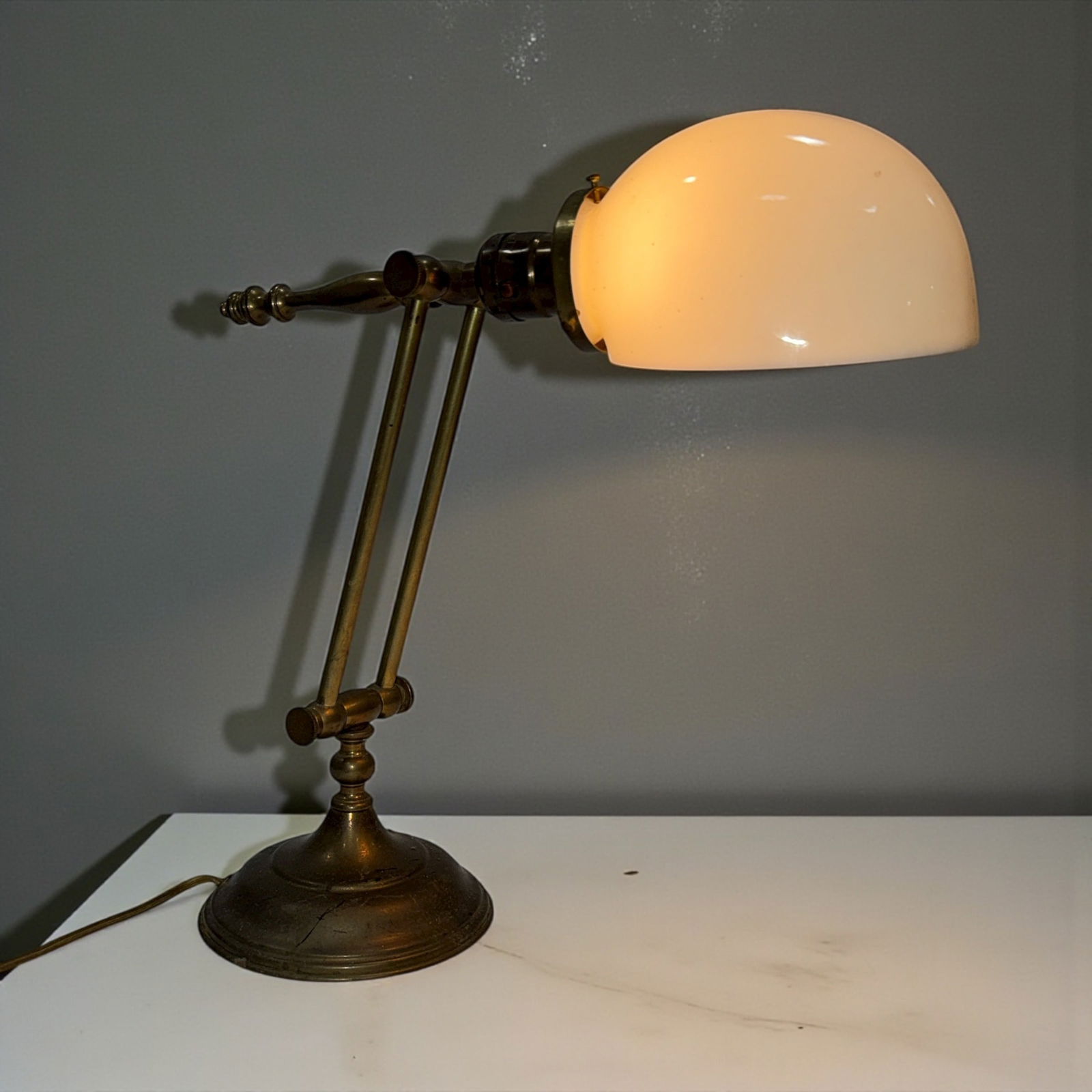 An Antique Brass & Milk Glass Executive's Desk Lamp: 14"H x 5.5" base Diameter, 14" deep, signed Leviton