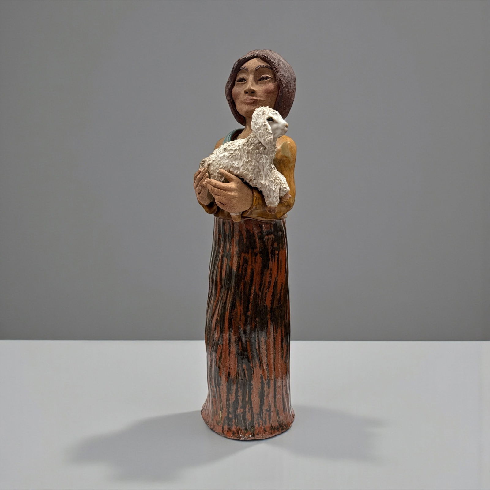 JIM JACKSON (American, b.1963) Native American Woman Ceramic Sculpture: Signed and Dated 1985 on back. Measures 22" H x 6.5" W x 5" DIA at base.