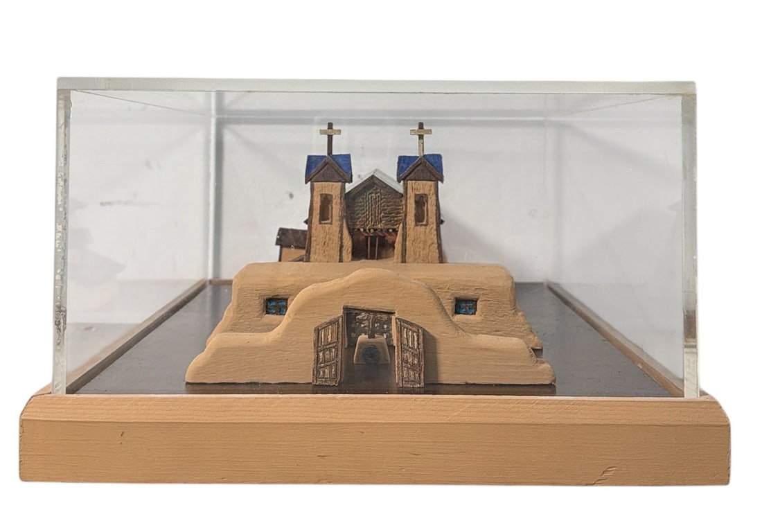 A Ceramic Model of El Santuario de Chimayo: Signed backwards on the base of the structure, A. Rios, Santa Cruz. Measures 7" H x 12" W x 15.25" D.