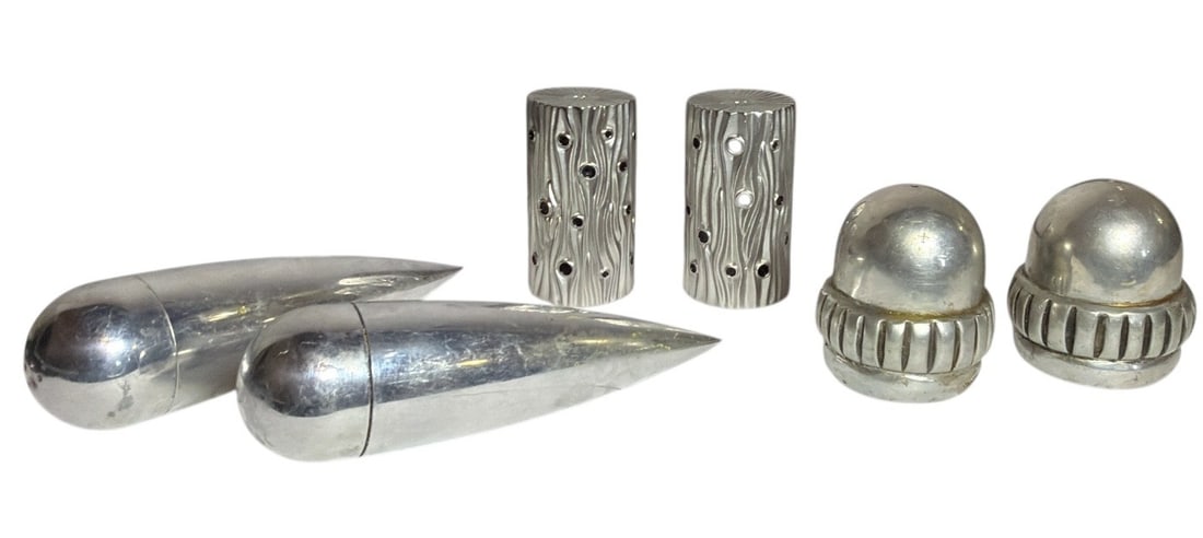 Three Salt and Pepper Shakers, L'OBJET, CARROL BOYES: The tree trunk black and silver L'Objet shakers measure 2.75" H x 1.5" diameter, the acorn shakers by Carrol Boyes measure 2.25" H x 2" diameter, and the space age shakers measure 5.5" long x 1.5" dia