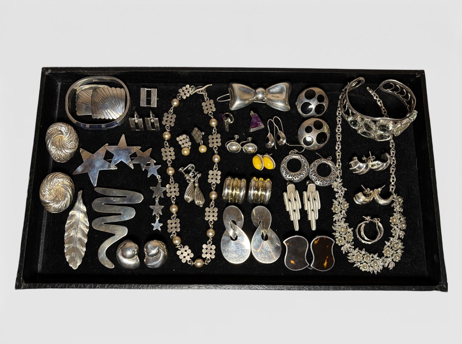 Collection of Sterling Silver Jewelry: Includes sterling silver, Mexican sterling, artist signed pieces, tortoise shell, amethyst, pearls, and more. The sterling silver and pearl necklace with matching earrings measures 11.43ozt without cu