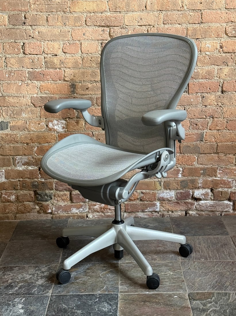 HERMAN MILLER Aeron Chair: Seat height ranges 17-23" H, 38-44" H to back. 27" W x 25" D. Herman Miller stamp to back side of backrest.