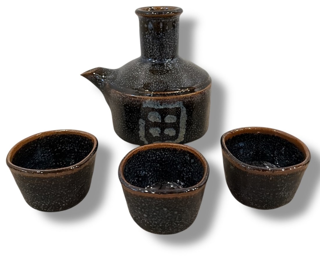 Raku Stoneware Sake Bottle and Cups: The sake bottle measures 5.25" H x 4.5" overall diameter, the cups measure 1.5" H x 2.75" diameter.