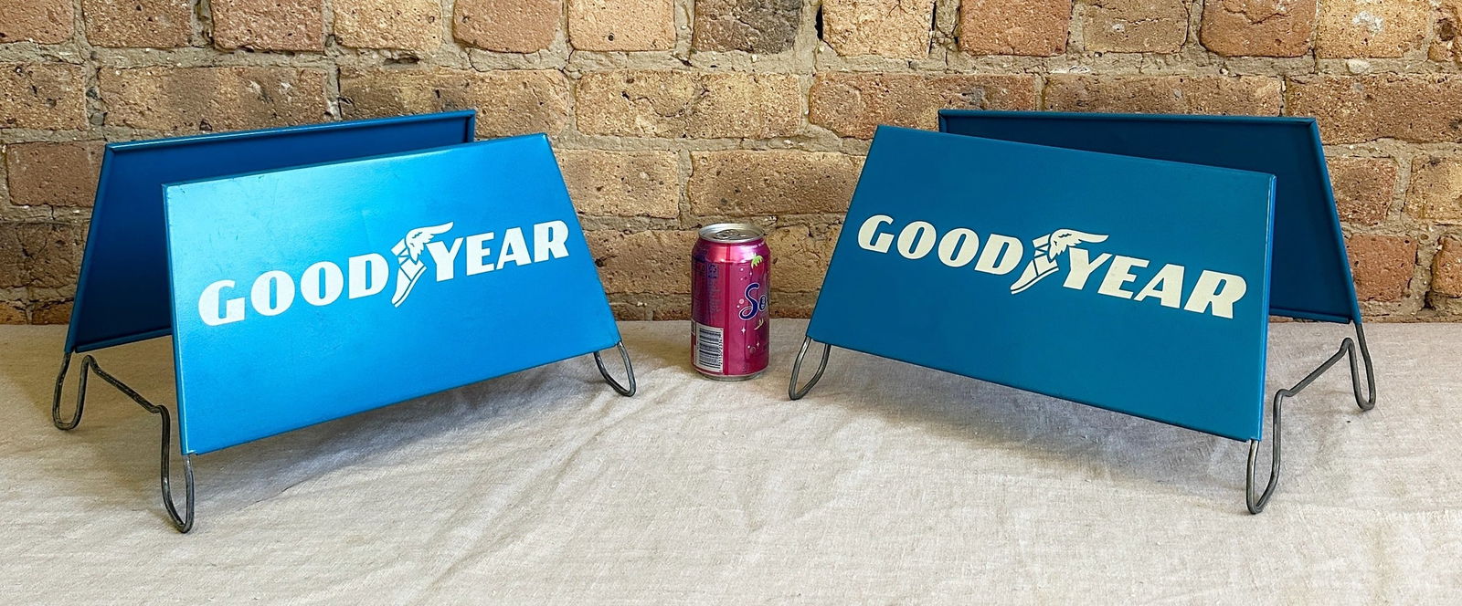 Vintage GOODYEAR Tire Rack Advertising Signs: New old stock, Circa 1975, never used. Metal signs with stand. Measure 8" H x 13.75" W x 10.5" D set up. From a multi-generational, family-owned service station in Chicago.