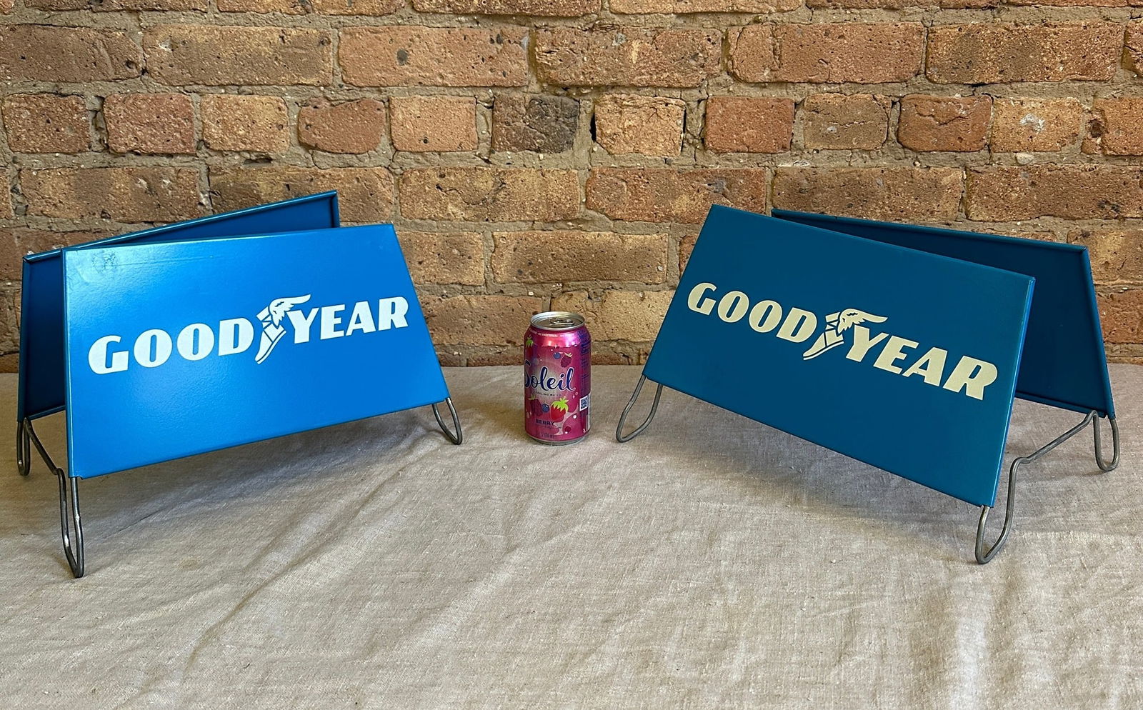 Vintage GOODYEAR Tire Rack Advertising Signs: New old stock, Circa 1975, never used. Metal signs with stand. Measure 8" H x 13.75" W x 10.5" D set up. From a multi-generational, family-owned service station in Chicago.