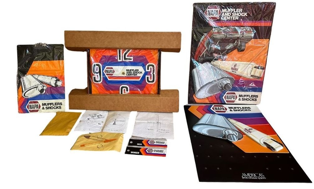 Vintage NAPA Muffler and Shock Center Automotive Advertising Kit: New old stock never used. Includes Clock, clipboard, bathroom keychains, key holder panel, and another 3-d advertising panel. Clock measures 17" H x 17" W x 1" D but does not run. Clipboard is 16.25"