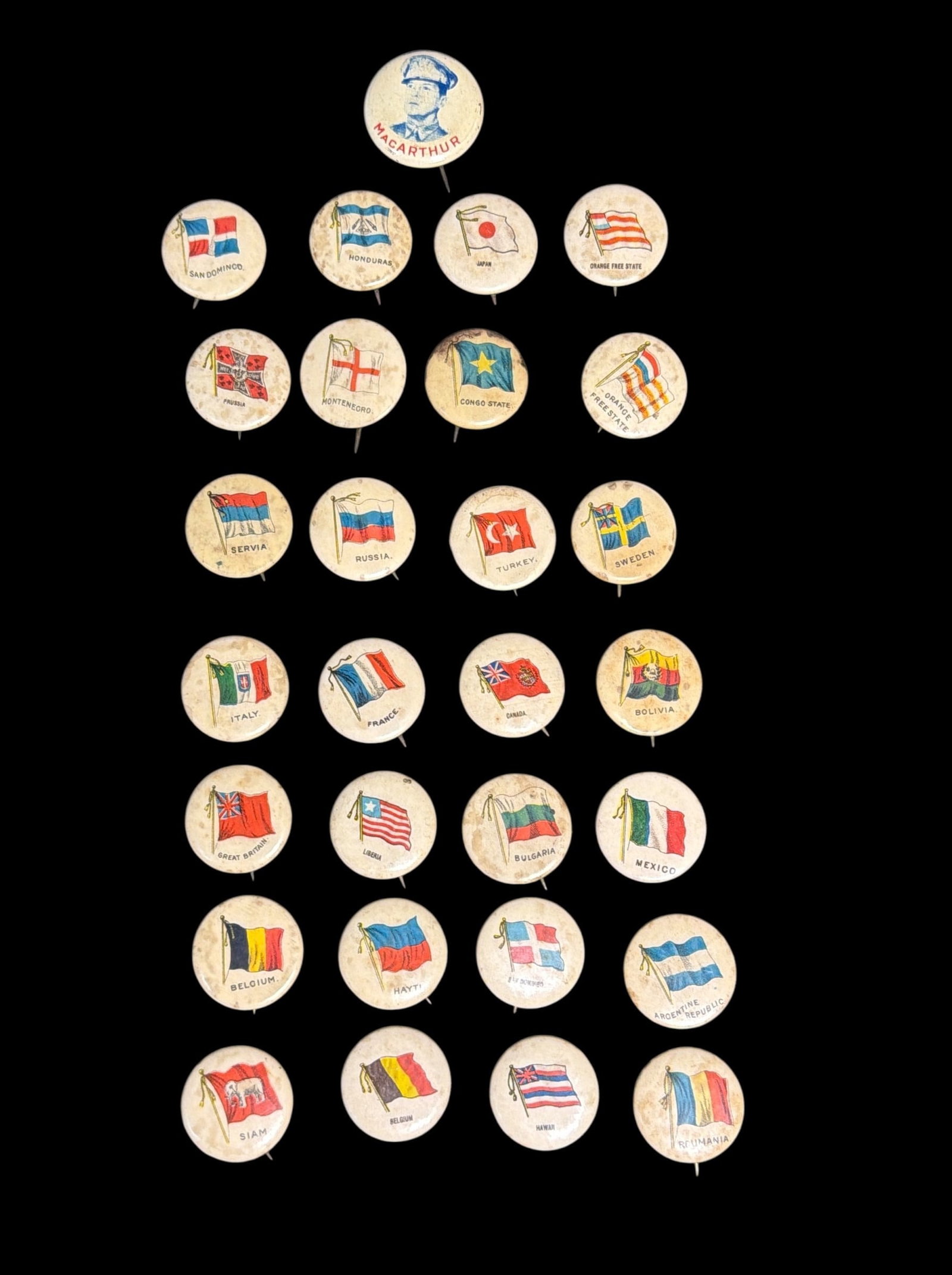 Collection Antique SWEET CAPORAL Cigarette Country Flag Button Pins: C. 1890's. All measure approx. 0.75"-1" diameter. Celluloid pinback button of General Douglas MacArthur measures approx. 1" diameter.