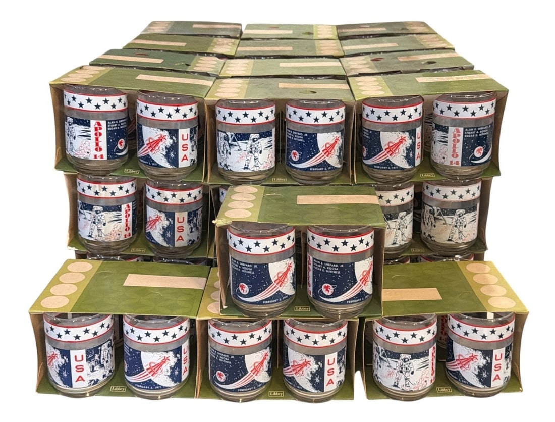 Large Collection NOS Vintage 1970's "Apollo 14" LIBBEY Glasses: Each glass measures 4.25" H x 2.75" diameter at top. Approx. 60+ glasses. All have original packaging. Featured in the next lot is the original advertising poster for the free Libbey Apollo 13