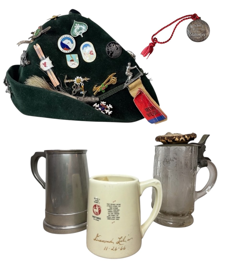 Assorted German OKTOBERFEST Beer Steins and Alpine Hat: Includes a traditional suede German Alpine hat with assorted skiing pins, three beer steins, one including dice in the base, and a "Patron Saint of Skiers" commemorative coin. The largest pieces is