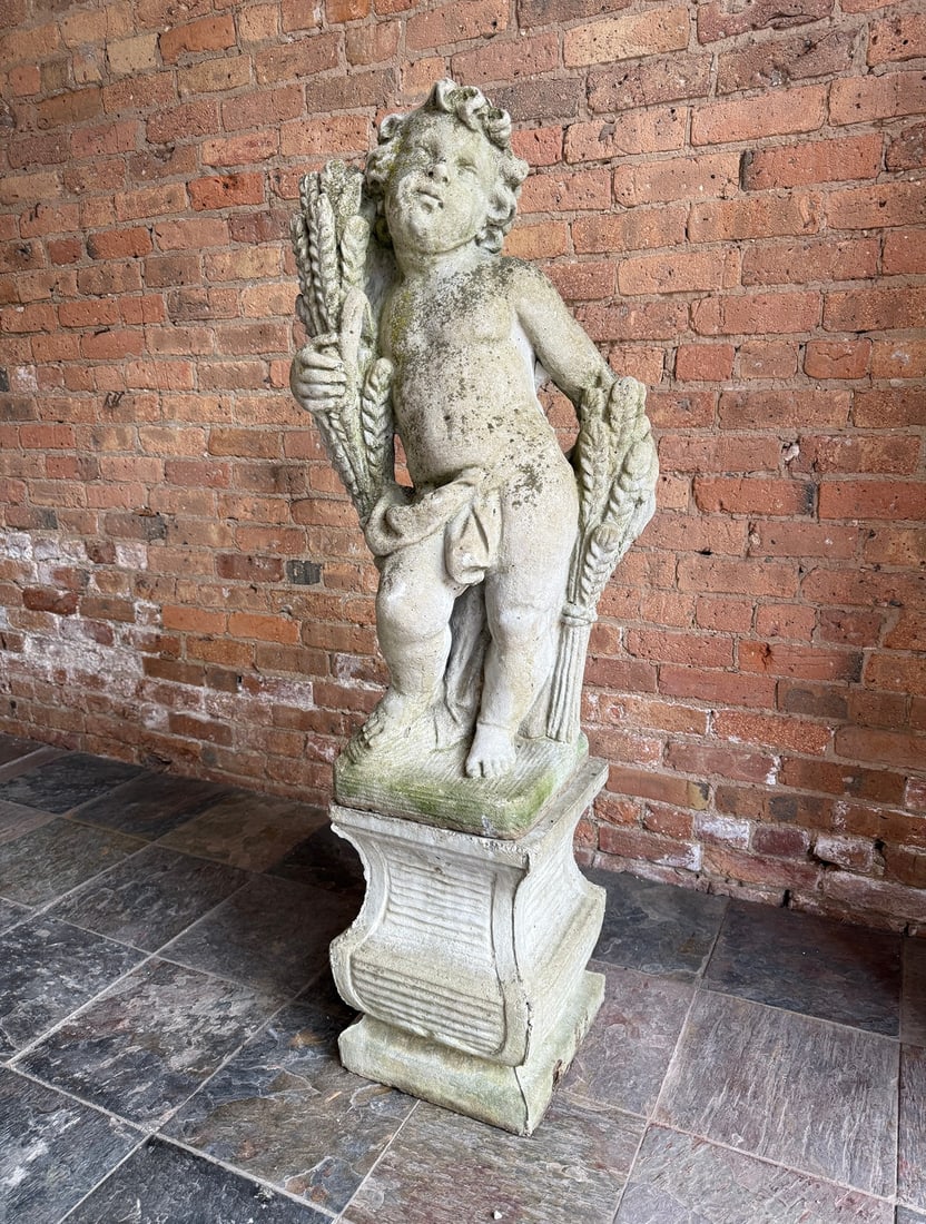 Early 20th C. Four Seasons Cherub Garden Statue, Fall: Cast stone, comes in two pieces. Base is more contemporary. Measures 52.75" H overall x 17" W x 14" D. Statue measures 36" H x 17" W x 14" D. Base measures 16.75" H x 12" W x 12" D.