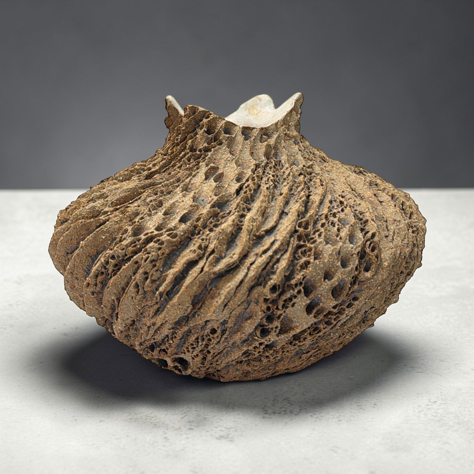 ANNE GOLDMAN Ceramic Vessel: Stoneware with iron slip, signed on the base. Measures 6.5" H x 7.5" overall diameter.