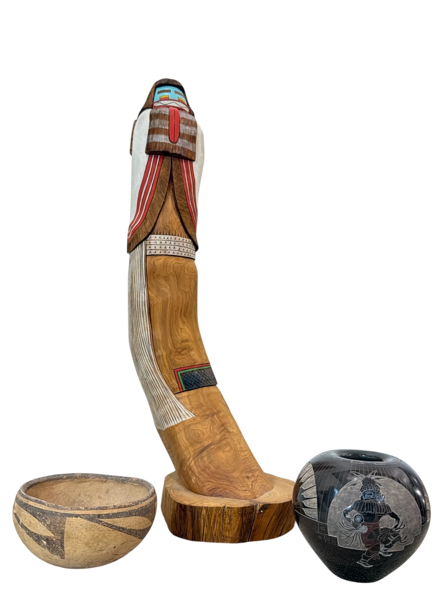 Collection of Hopi and Navajo Native American Articles: Includes a carved wood kachina titled "Heoto Mana" by Fred Krouh that measures 16.25" H x 4.5" W x 6" D, a small ceramic Hopi pot that measures 1.25" H x 3.75" overall diameter, and a Navajo Fabian