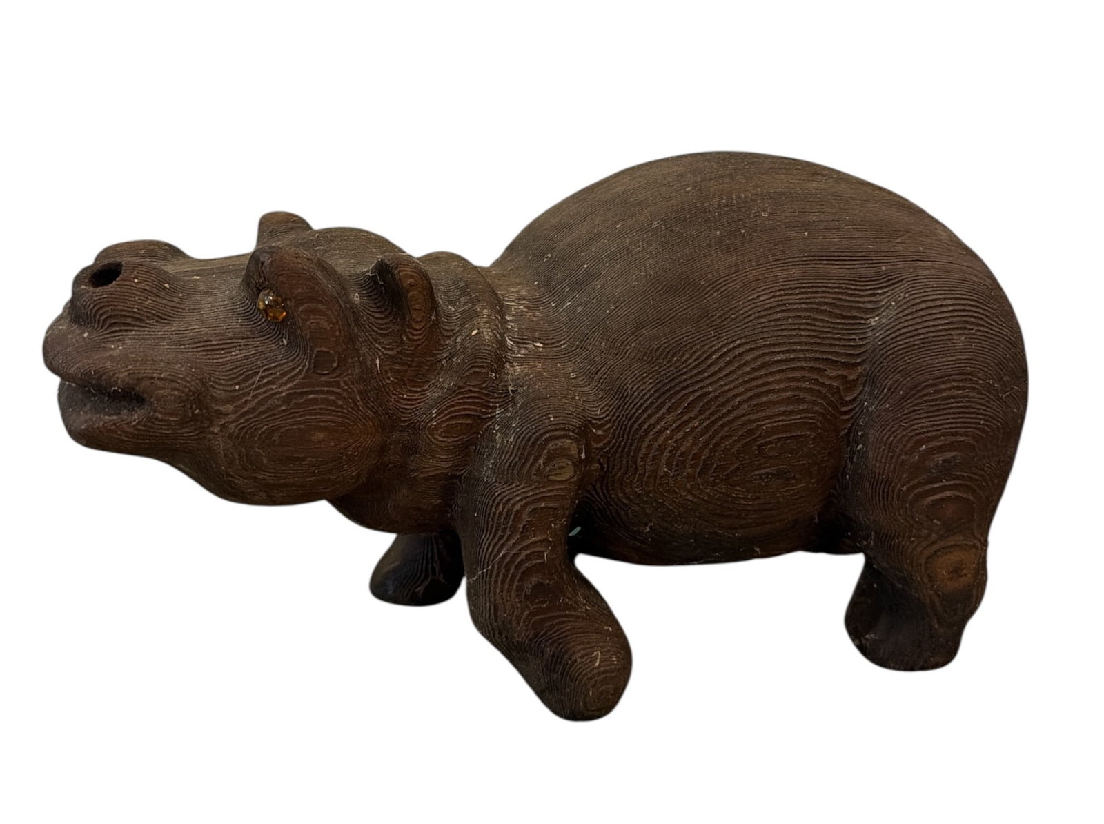 A Carved Wood Hippopotamus Sculpture: Carved wood and glass eyes. Measures 7" H x 5" W x 13" D.