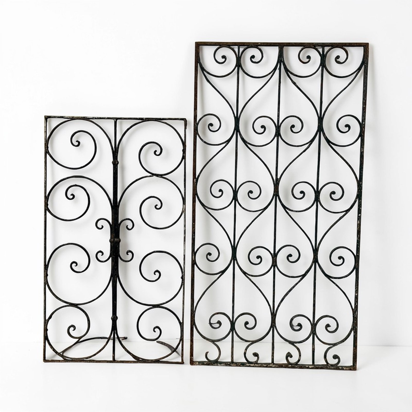 2 French Wrought Iron Architectural Panels: Left fence measures 37.25" H x 21.25" W x .5" D. Right fence measures 48.25" H x 25" W x .75" D., typically found on Hausmann type buildings in Paris.