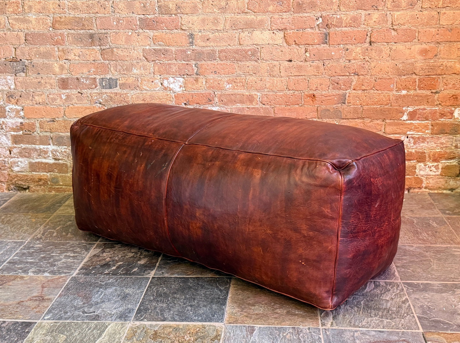 Large Brown Leather Ottoman Pouf: 21" H x 52" W x 24" D.