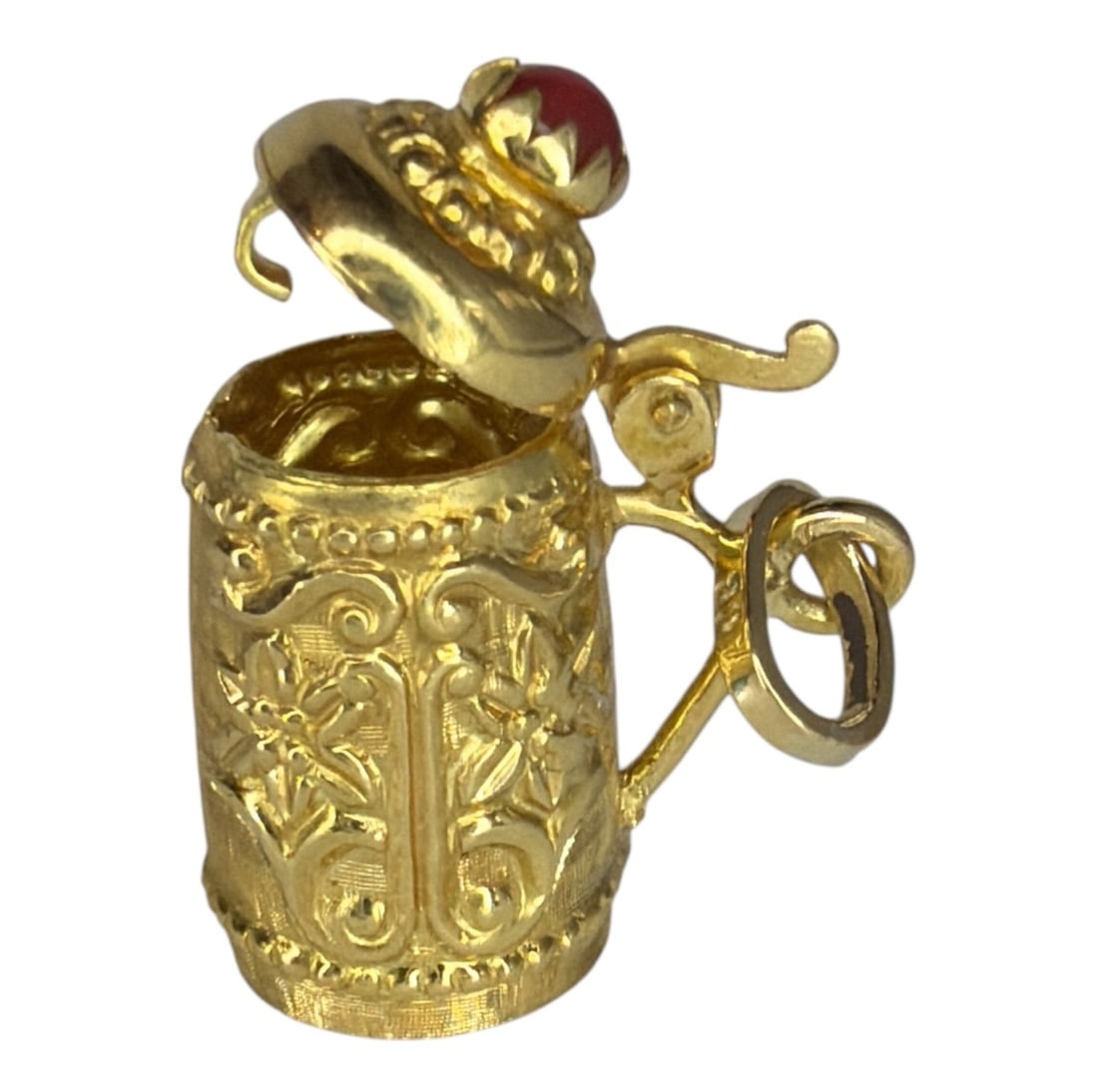 An 18k Gold & Ruby German Stein Charm, Opens: Measures 1.75" H x .5" diameter. The ruby measures approx. 4mm diameter. Charm measures 3.03dwt including stone.