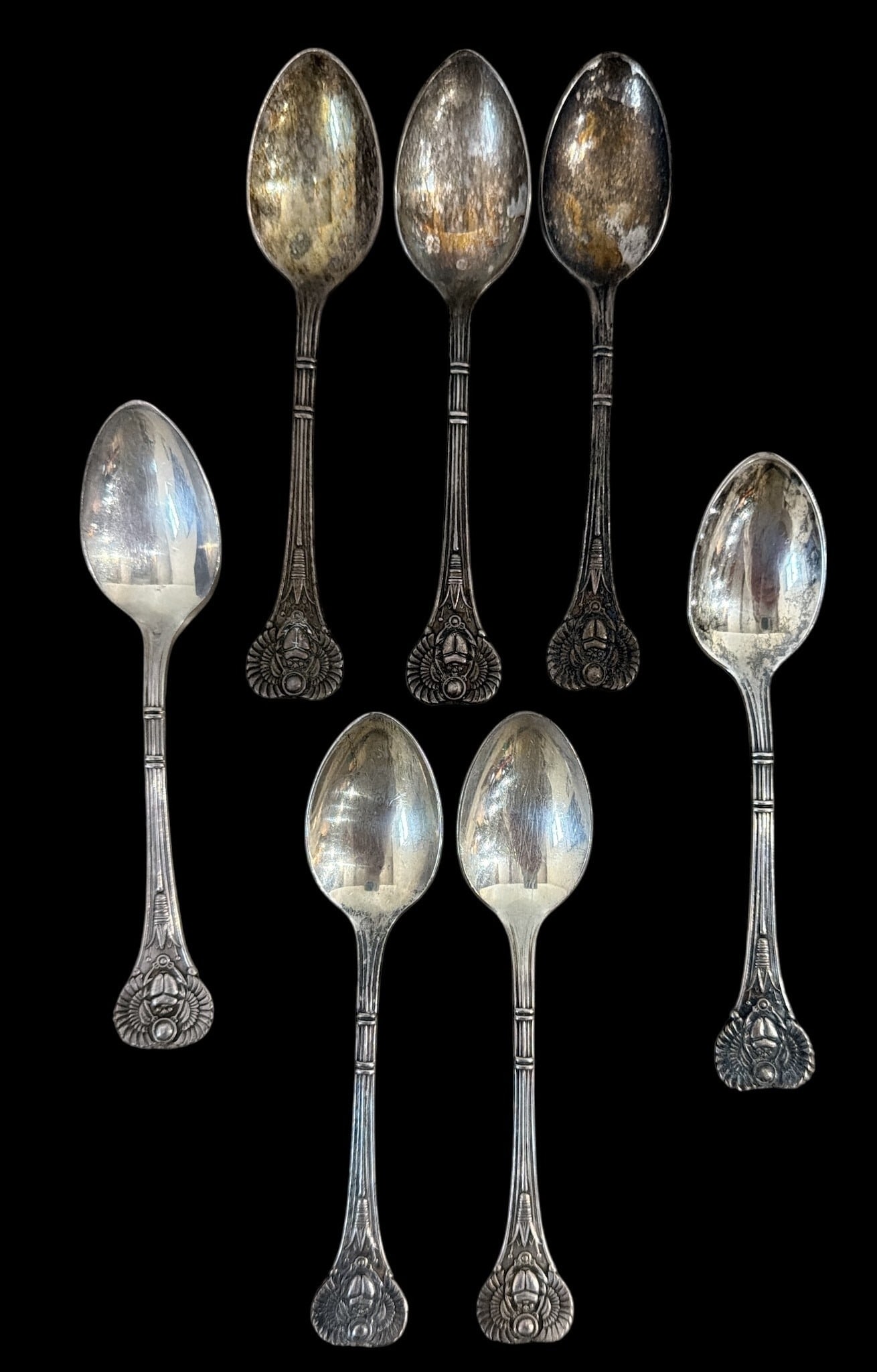 Set of Seven CAFE L'OPERA Egyptian Scarab Demitasse Spoons: Likely from the Cafe L'Opera in New York. Designed in line with the restaurant and nightclub, the spoons feature an art deco era Egyptian scarab design. All measure 4.25" x 1" W.