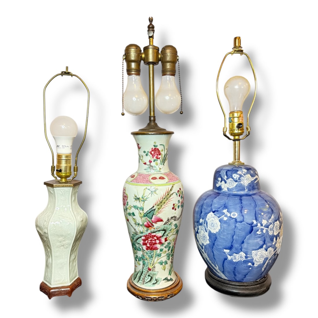Three Asian Lamps, Porcelain and Celadon: The tallest lamp is the famille rose style lamp and it measures 24.5" H to the finial x 6" overall diameter.