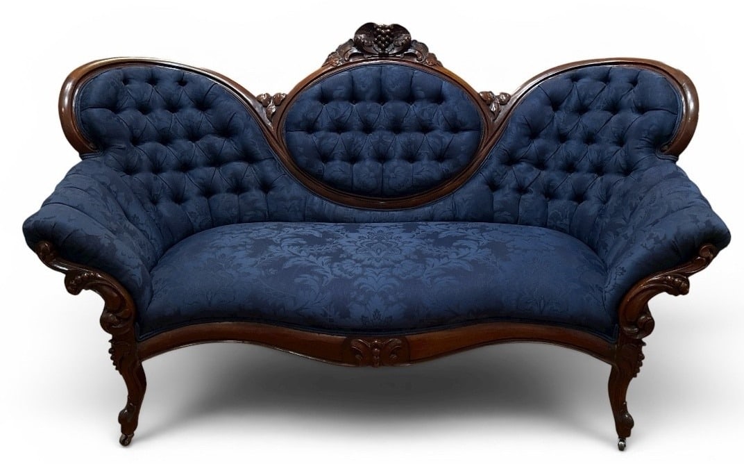 19th C. Rococo Revival Walnut Settee, Mod Upholstery: Gorgeous dark blue tufted upholstery, carved walnut featuring fruit and leaf motif, cabriole leg and casters. Measures 38.5" H to the back x 16.5" H to the seat x 66" W x 31"D.