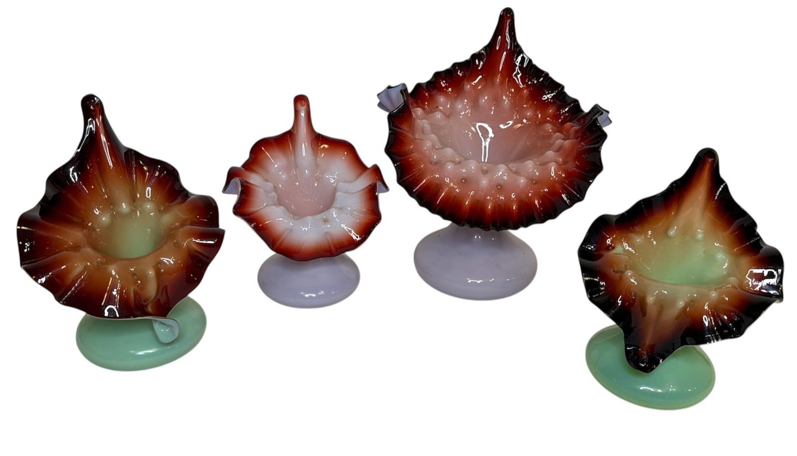 Collection of Oxblood, Lavender, and Green Art Glass Jack In The Pulpit Vases: Featuring two lavender and oxblood hobnail jack-in-the-pulpit victorian vases in addition to two oxblood and green vases. All four vases have hobnail detailing at the opening. The largest measures 7.5