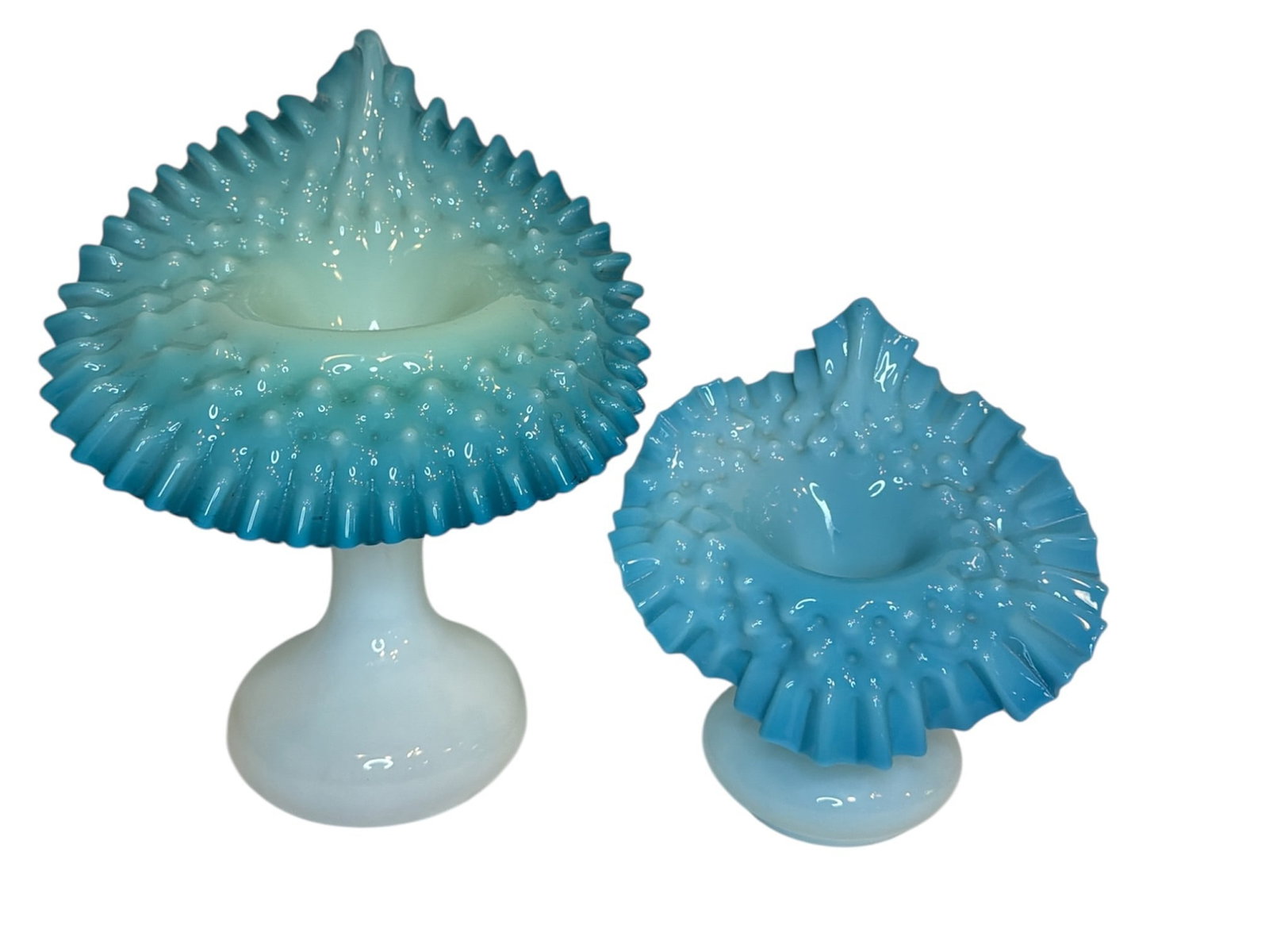 Two Victorian Hobnail Blue, Milk Glass, & Uranium Jack In The Pulpit Vases: Two victorian hobnail jack-in-the-pulpit vases, one is milk glass and blue hobnail and the other is uranium milk glass and blue. Both are likely Fenton. The larger vase measures 11" H x 9" W x 6" D, t