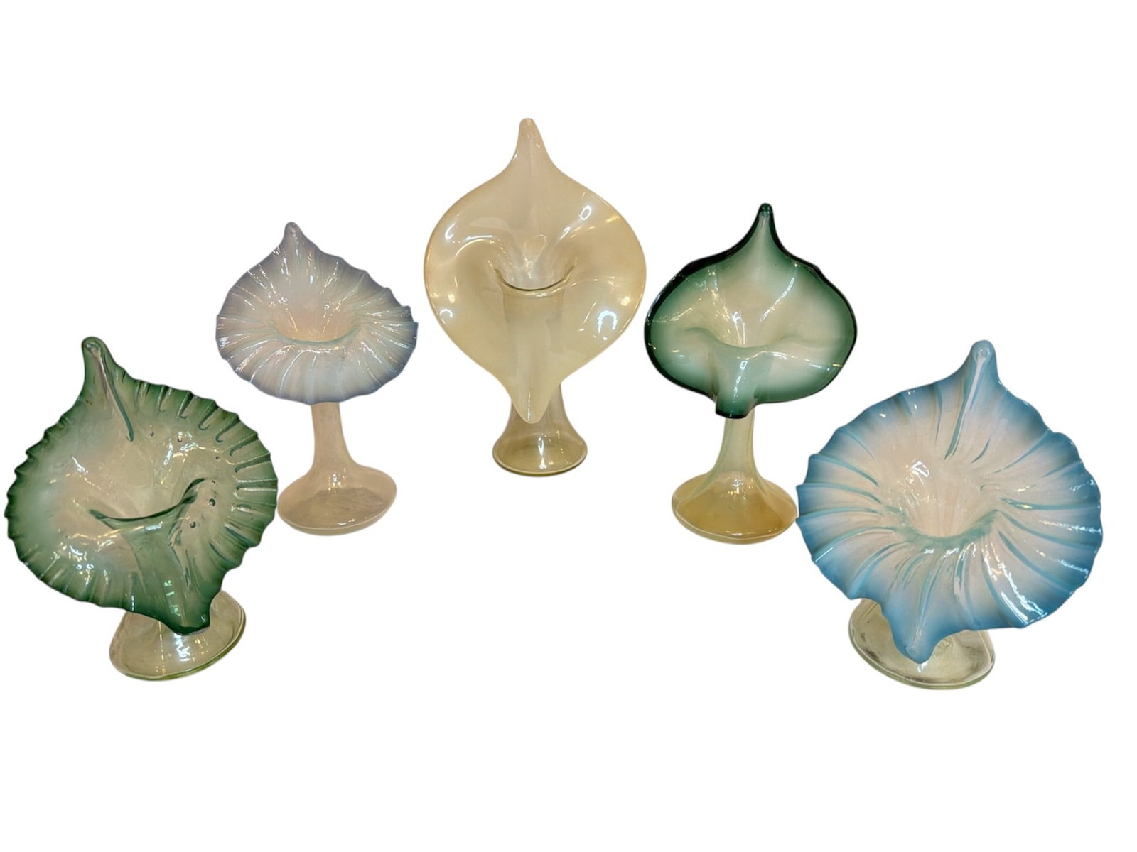 Collection of Victorian Uranium Glass Jack In The Pulpit Vases: Includes a mix of victorian uranium, blue, green, and teal jack-in-the-pulpit vases. The largest measures 10.25" H x 6.5" W x 3" D, the smallest measures 7.25" H x 5" W x 3" D.