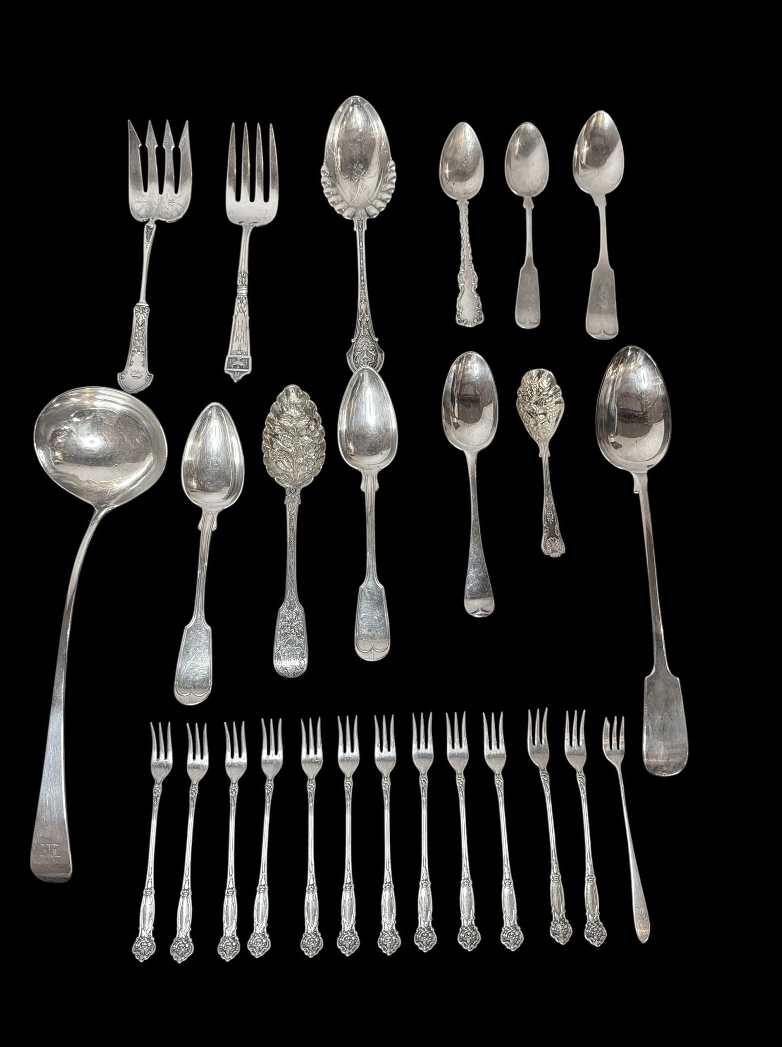 Assortment of Sterling Silver and Silverplate Serving Articles: Includes an assortment of serving spoons, serving forks, and hor d'oeuvres forks. Largest serving spoon is the ladle that measures measures 13.25" x 4" W.