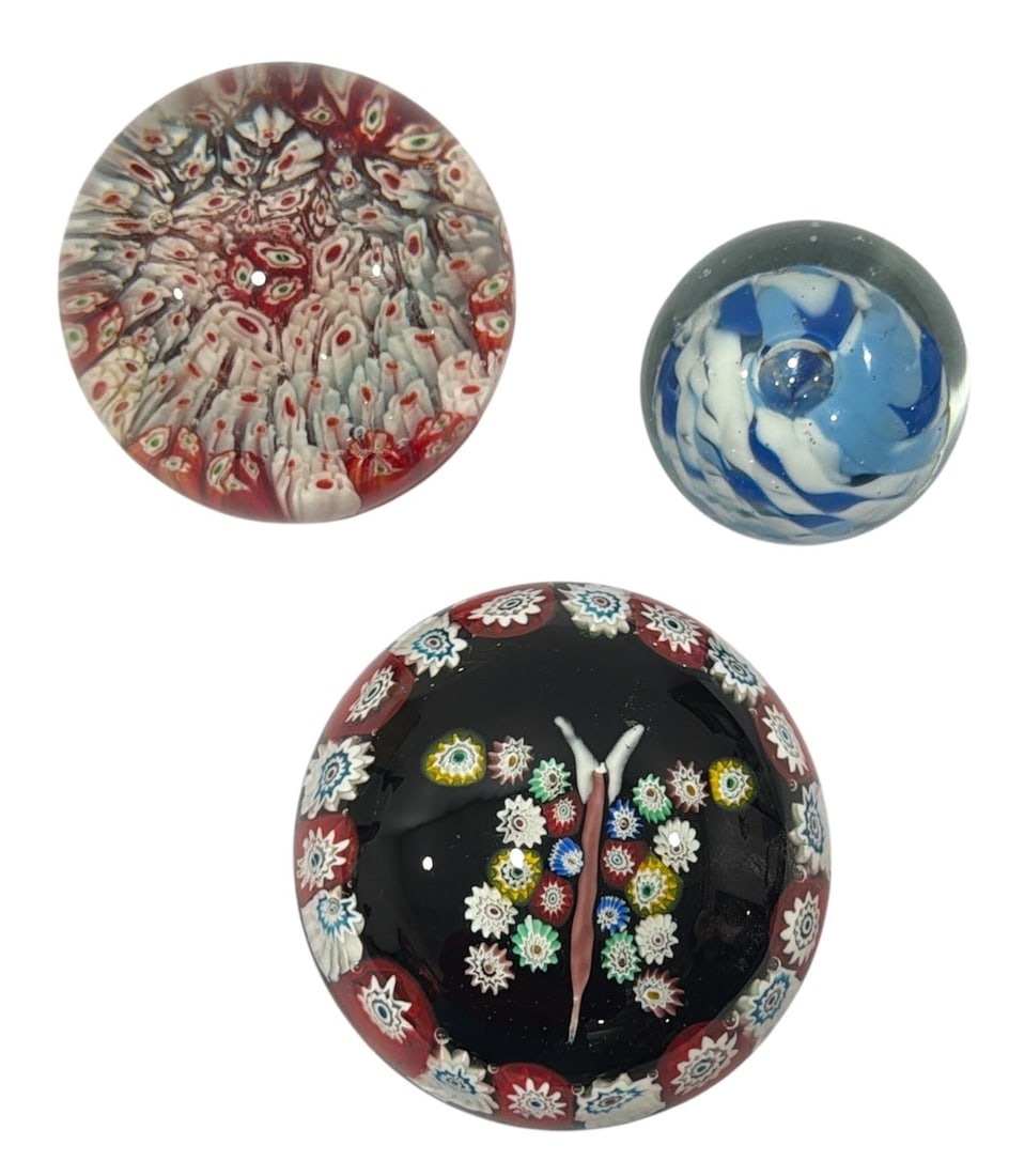 Three Vintage Art Glass Paperweights, MILLEFIORI, GLASS EYE STUDIOS: Includes three paperweights, two feature millefiori detailing and the other is marked Glass Eye 1983. The tallest measures 2.5" H x 2.5" diameter, the butterfly one measures 2" H x 3.5" diameter, and 