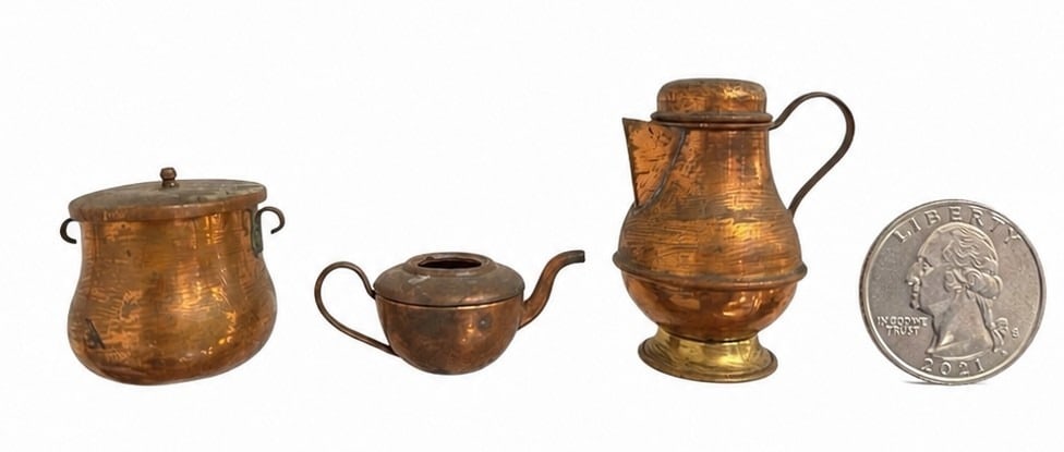 Three Diminutive Copper and Brass Articles: The largest measure 2.5" H x 1.5" diameter x 2.25" W from handle to spout, the tea kettle measures 1" H x 2.5" W spout to handle, 1.5" diameter, the pot measures 1.75" x 2" diameter.