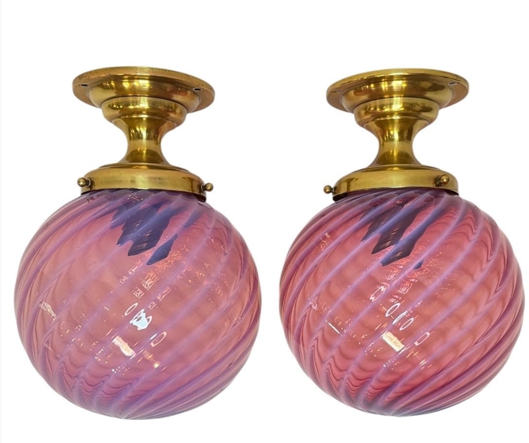 Antique Cranberry Swirl Globe Sconces, Pair: Cranberry glass globes on brass bases, they measure 10" x 7" diameter.
