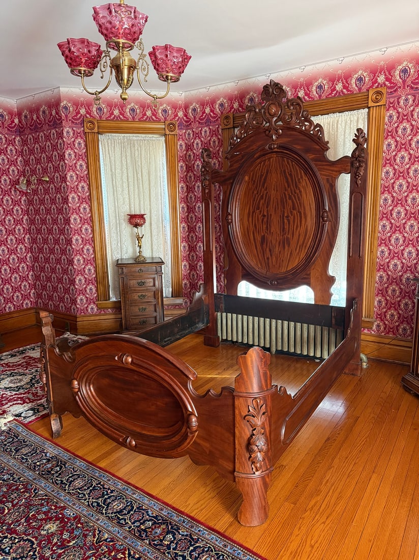 High Victorian 1890s Bed Frame: Flamed mahogany. Queen size bed frame. 97" H x 61" W x 80" D.