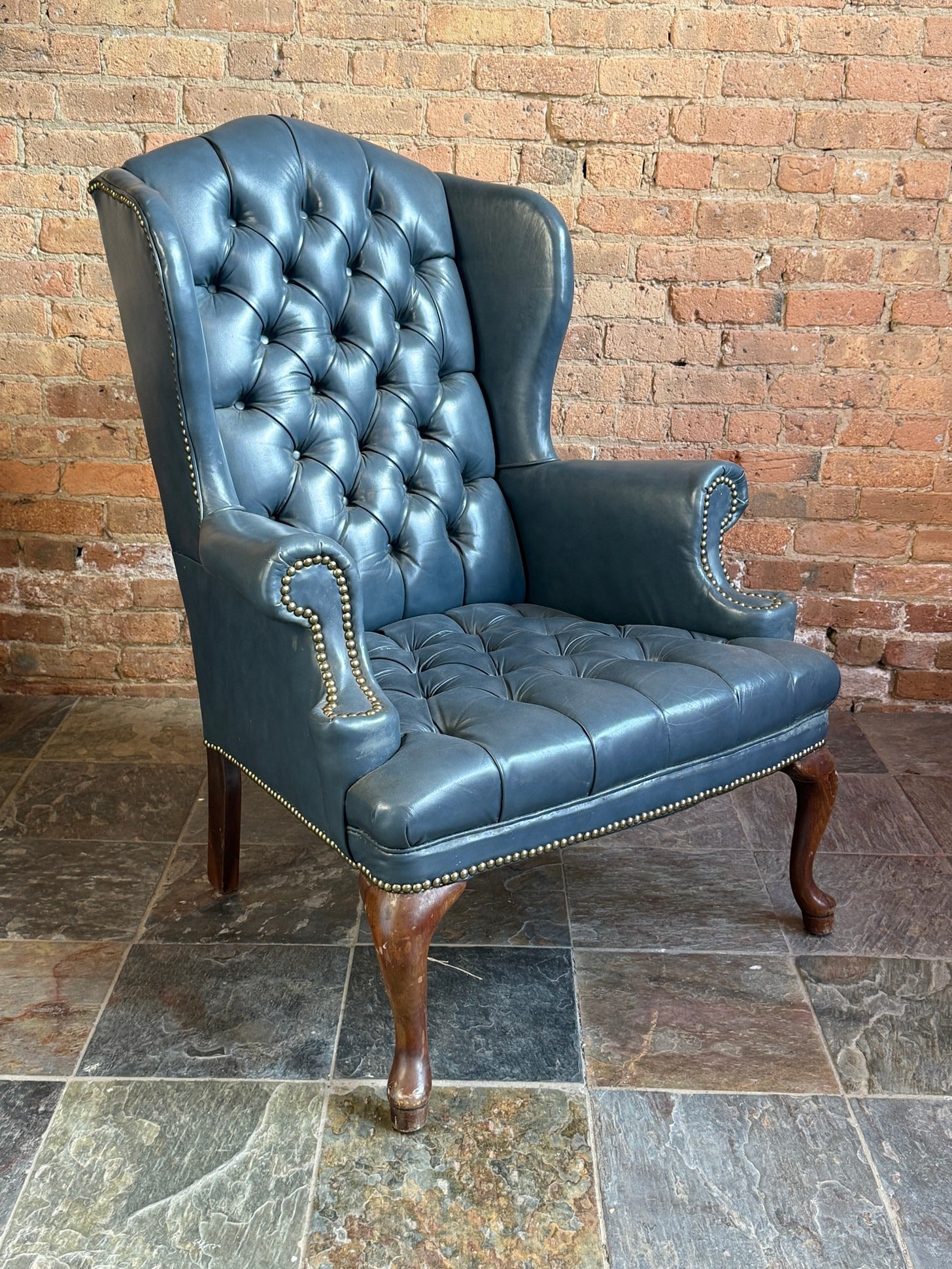 Blue Leather Chesterfield Nailhead Trim Armchair: Reminiscent of styles by Ralph Lauren. Measures 43" H, 17" H to the seat x 32" W x 35" D.