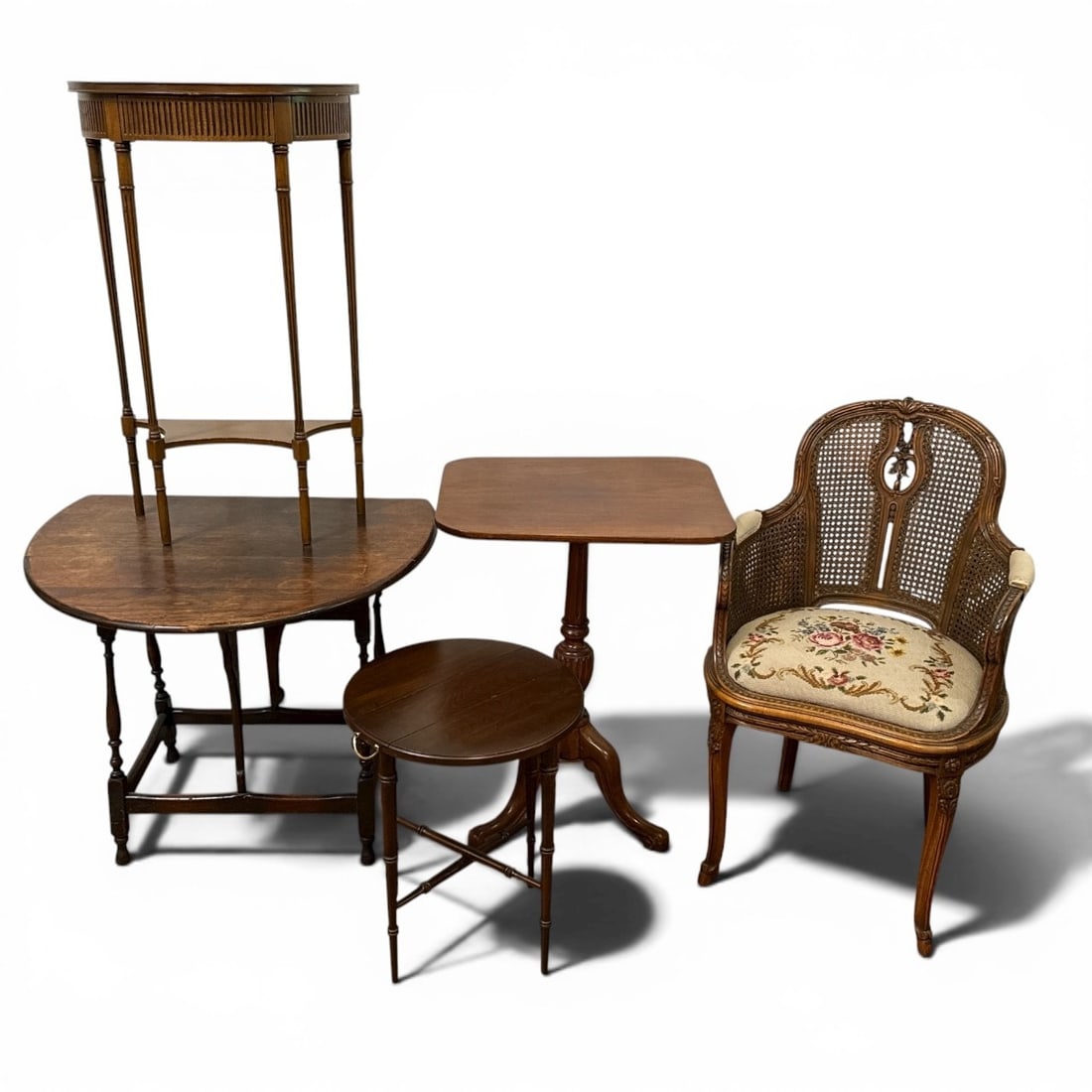 Assortment of Antique Furniture: Includes a cane back floral petit point armchair that measures 36" H to the back, 19" H to the seat x 22" W x 22" D, a gateleg pub table that measures 26.5" H x 26" W x 31" D, a demilune reeded style 