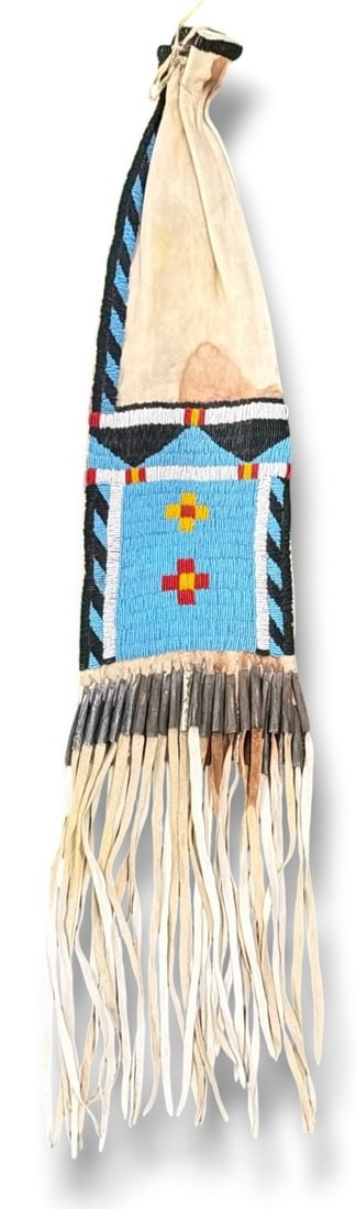 Lakota Sioux Native American Tobacco Bag, Circa 1920: 35.5" L x 7" W. This bag has all the indications of a pre-reservation bag, there is a stain which looks like blood on the front of it. Please see photos. The staining by the metal decoration appears t