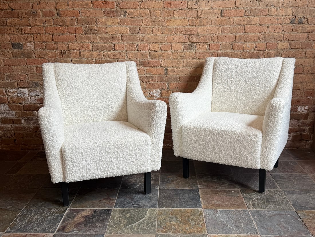 White Boucle Armchairs, Pair: In the style of Einar Larsen. Each measures 36.5" H to the back, 19" H to the seat x 34" W x 29" D.