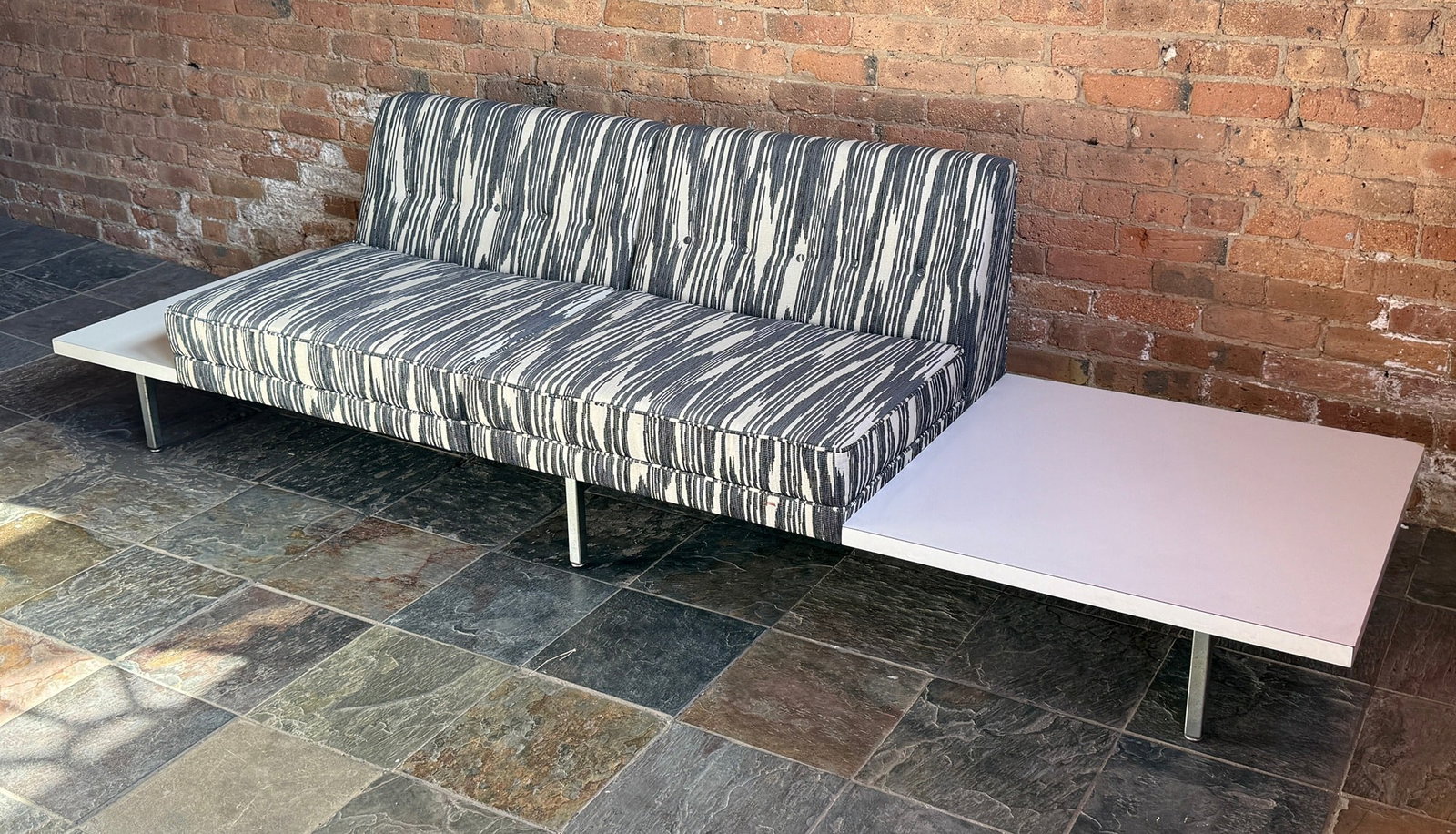 GEORGE NELSON Modular Seating Sofa, HERMAN MILLER: 27" H to back x 15.5" H to seat x 106" W x 26.5" D. Reupholstered in Pierre Frey ?Bourail? Jacquard fabric. Refoamed as well. White laminate side tables with metal frame.