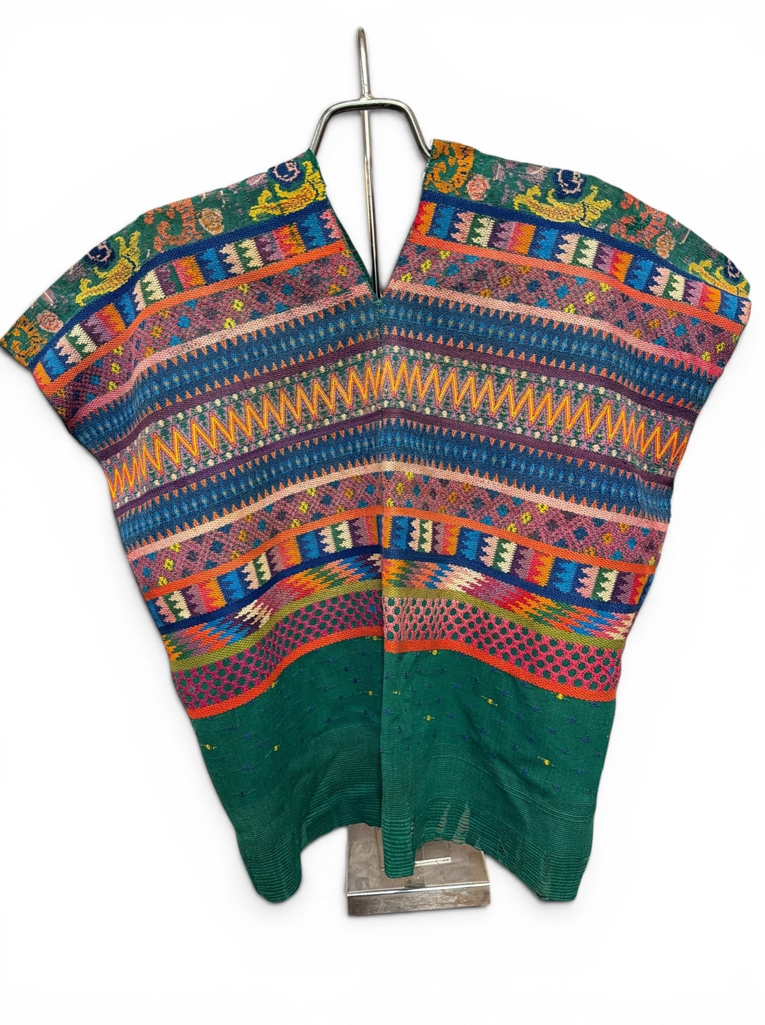 Guatemalan Embroidered Huipil: Measures 26" from shoulder to waist, 20" from shoulder to back hem x 25.5" W. Retains loops added to the back to be hung on a wall. Property from the Collection of Marjorie and Harvey Freed.