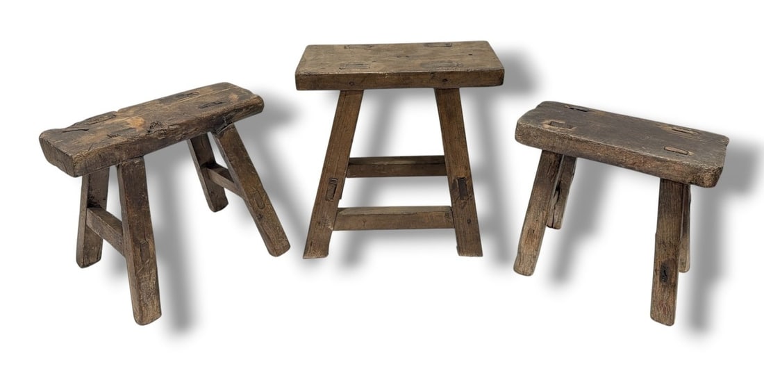 Three Primitive Milking Stools: The tallest measures 11.5" H x 12" W x 9" D, the second tallest measures 9.75" H x 11.5" W x 8.5" D, the smallest measures 9.25" H x 10" W x 6" D.