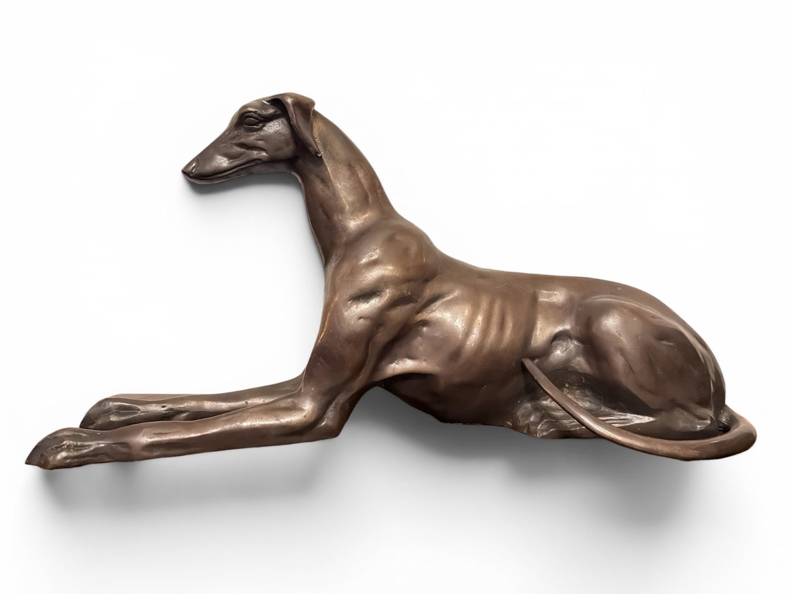 Art Deco Bronze Whippet Sculpture: Measures 12" H x 5.5" W x 24" D. Cast bronze.