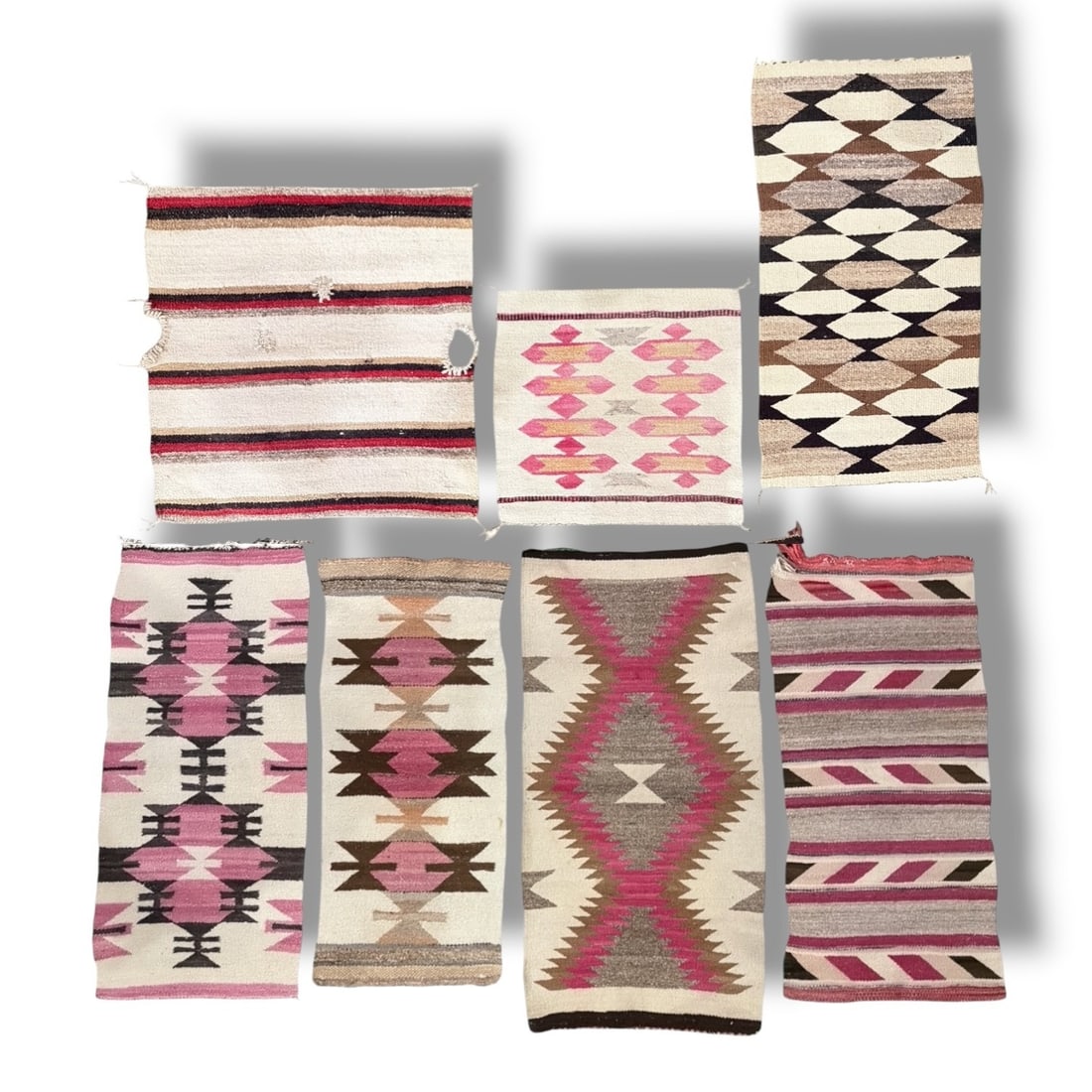 Seven Navajo Native American Wool Saddle Blankets: The largest measures 41.5" x 20.5", the smallest measures 18.5" x 18.5".